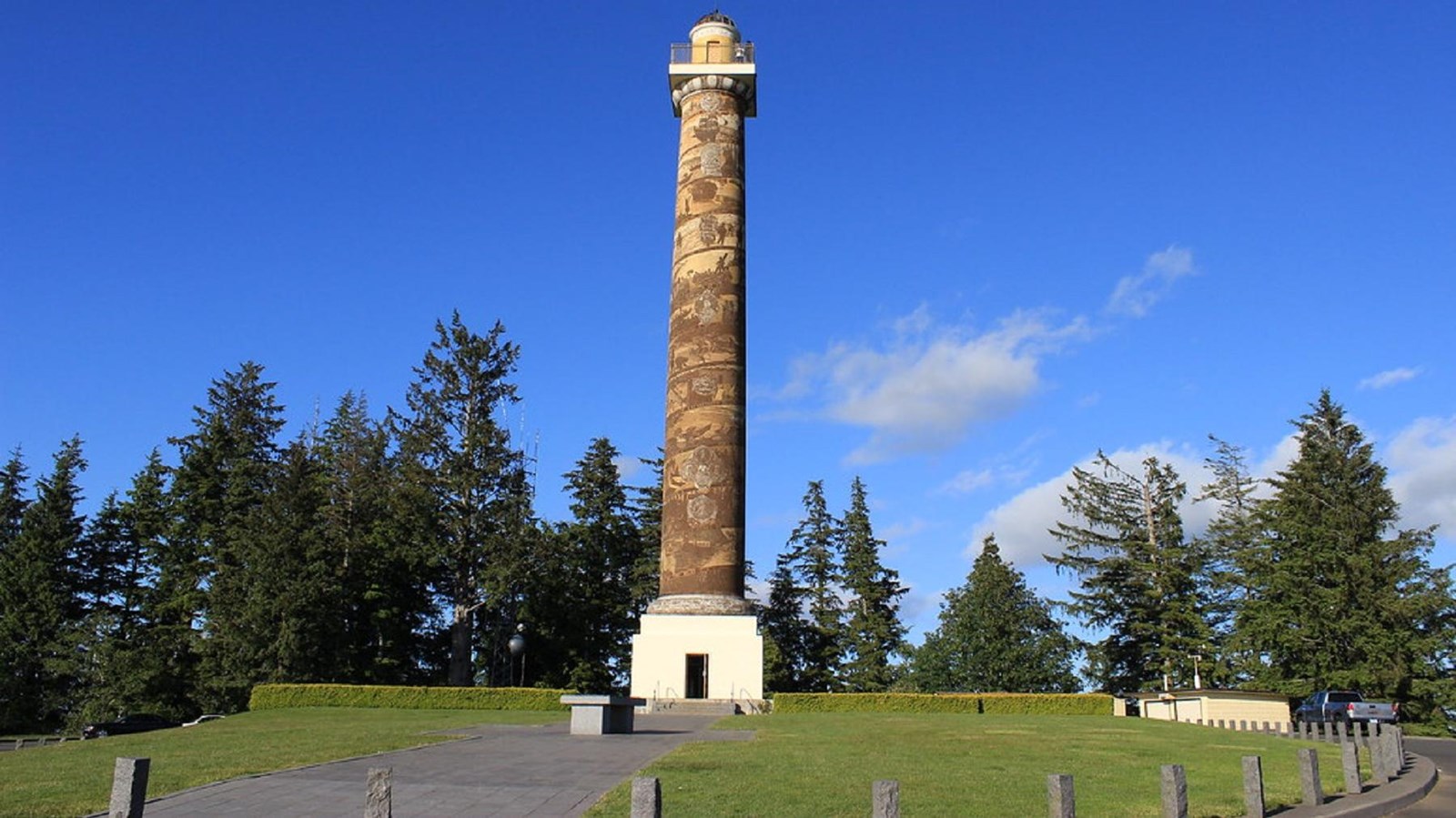 A tall column painted with scenes from Astoria\'s history rises into the air 