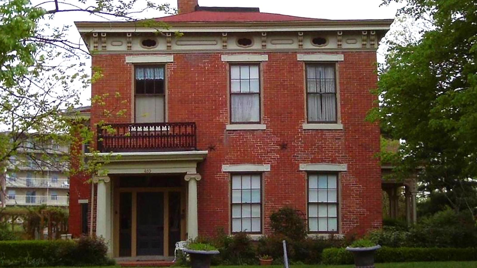Two-story red brick home in Greek Revival style 