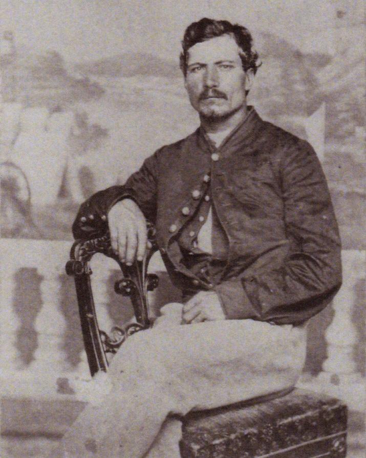 A man in a U.S. Civil War ear uniform sits on a chair.