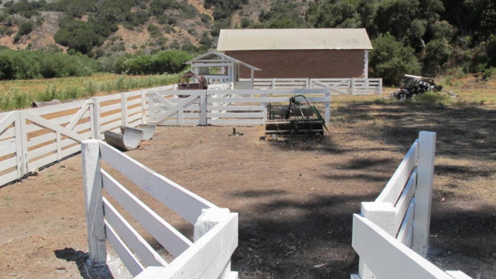 large livestock corral made of 5-foot-high white fencing.