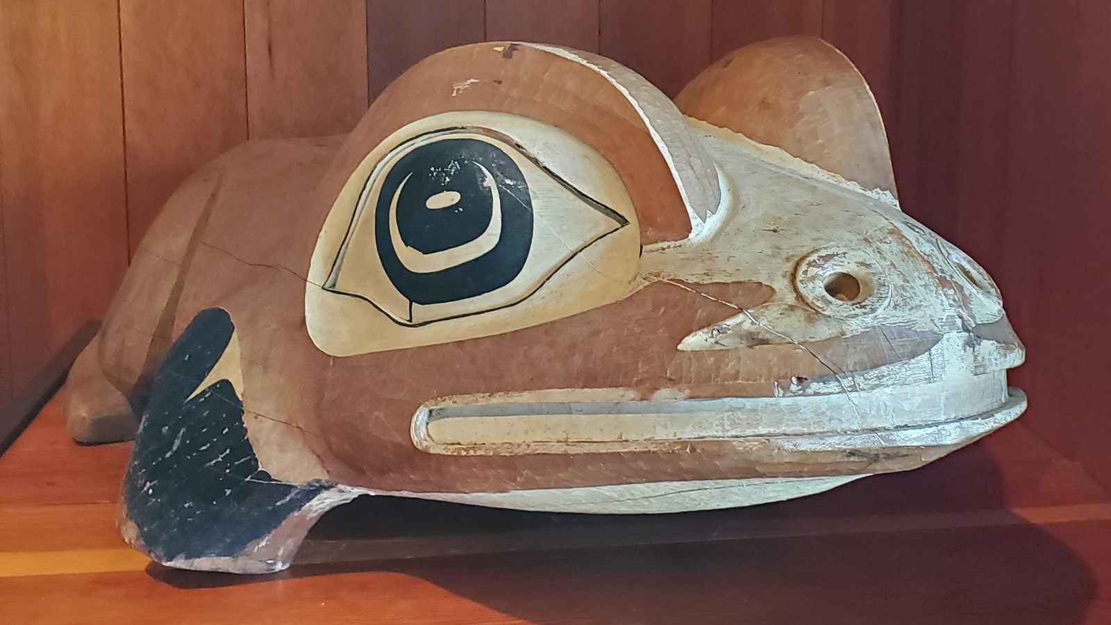 A wood carving of a Northwest coast stylized frog
