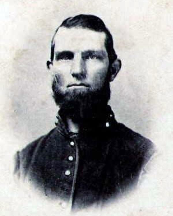 Man with a beard wearing a Union Civil War uniform. 