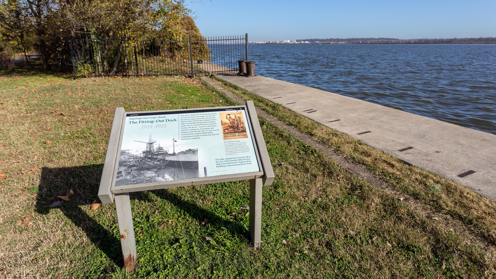 A black and white photo of a boat parked at a dock is pictured on the panel. 