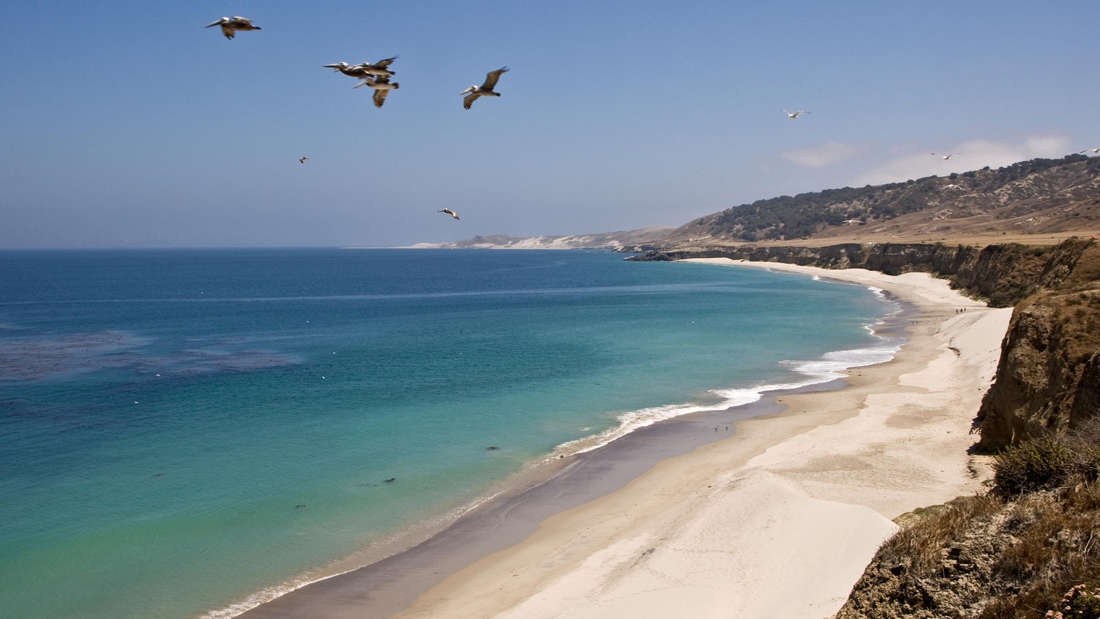 a long curve of sandy beach, at the bottom of Water Canyon, near the middle of Bechers Bay.