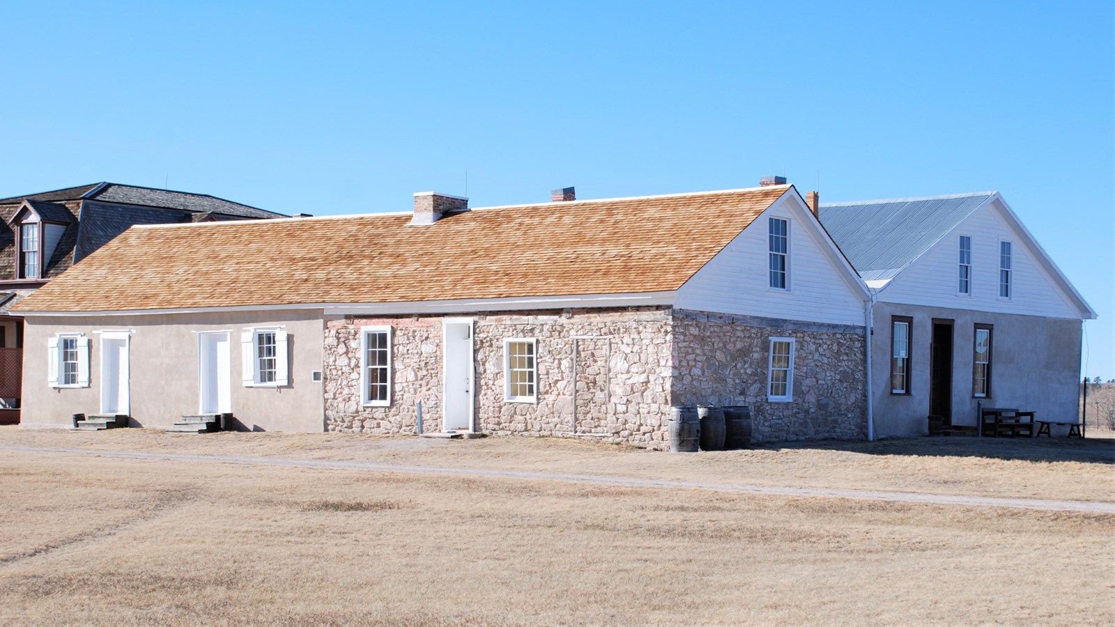 The post trader store is a double-gabled building of stone, adobe, and lime-grout cement.