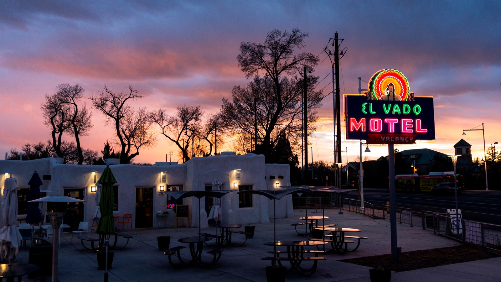 A sign with red and green neon lights reads 