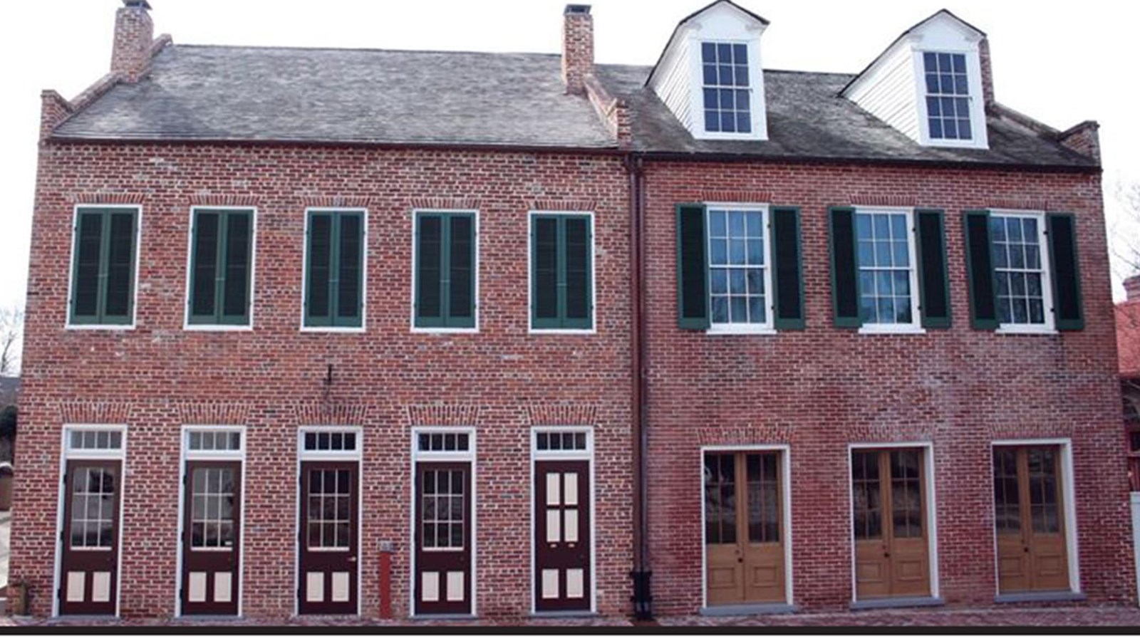 Two story brick house with dormer windows