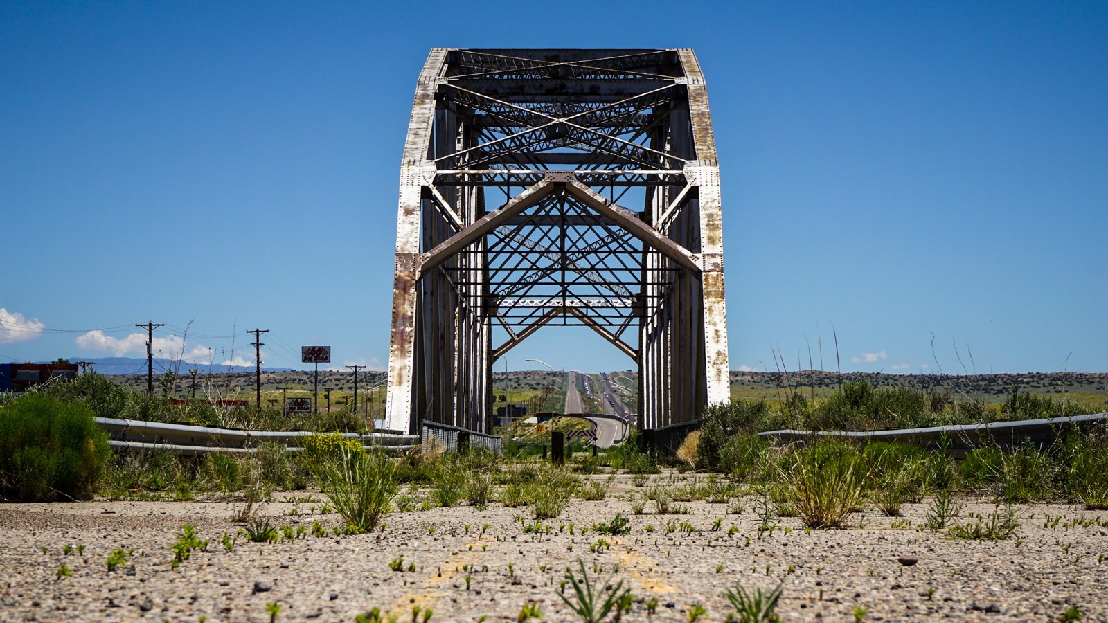 A large arched metal truss bridge spanning a river.