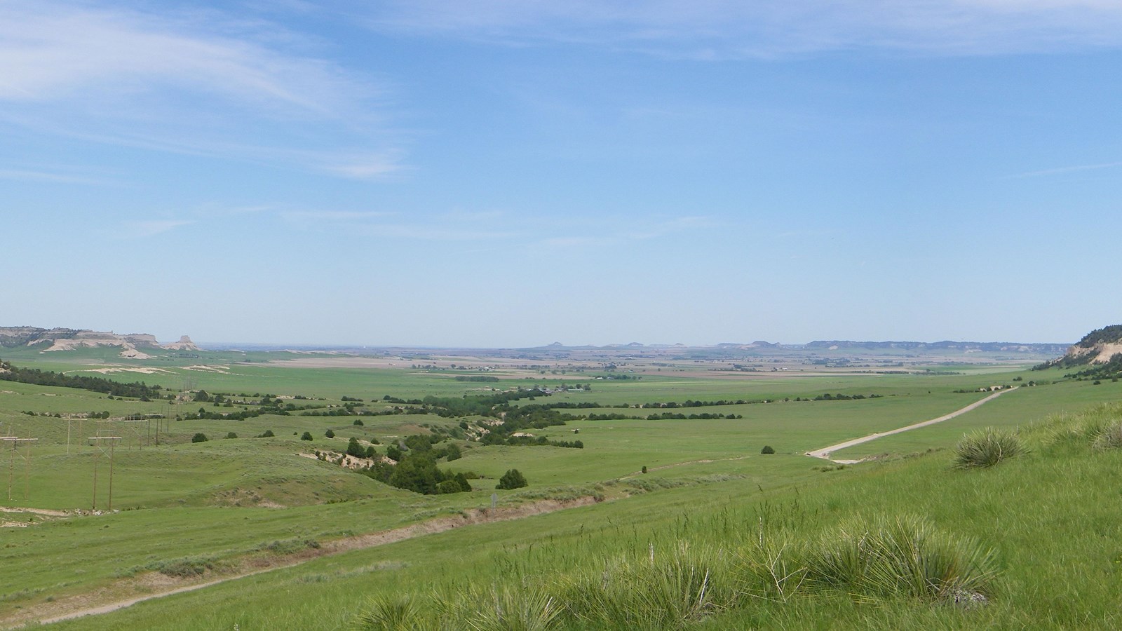 A wide, grassy pass between two bluffs. 