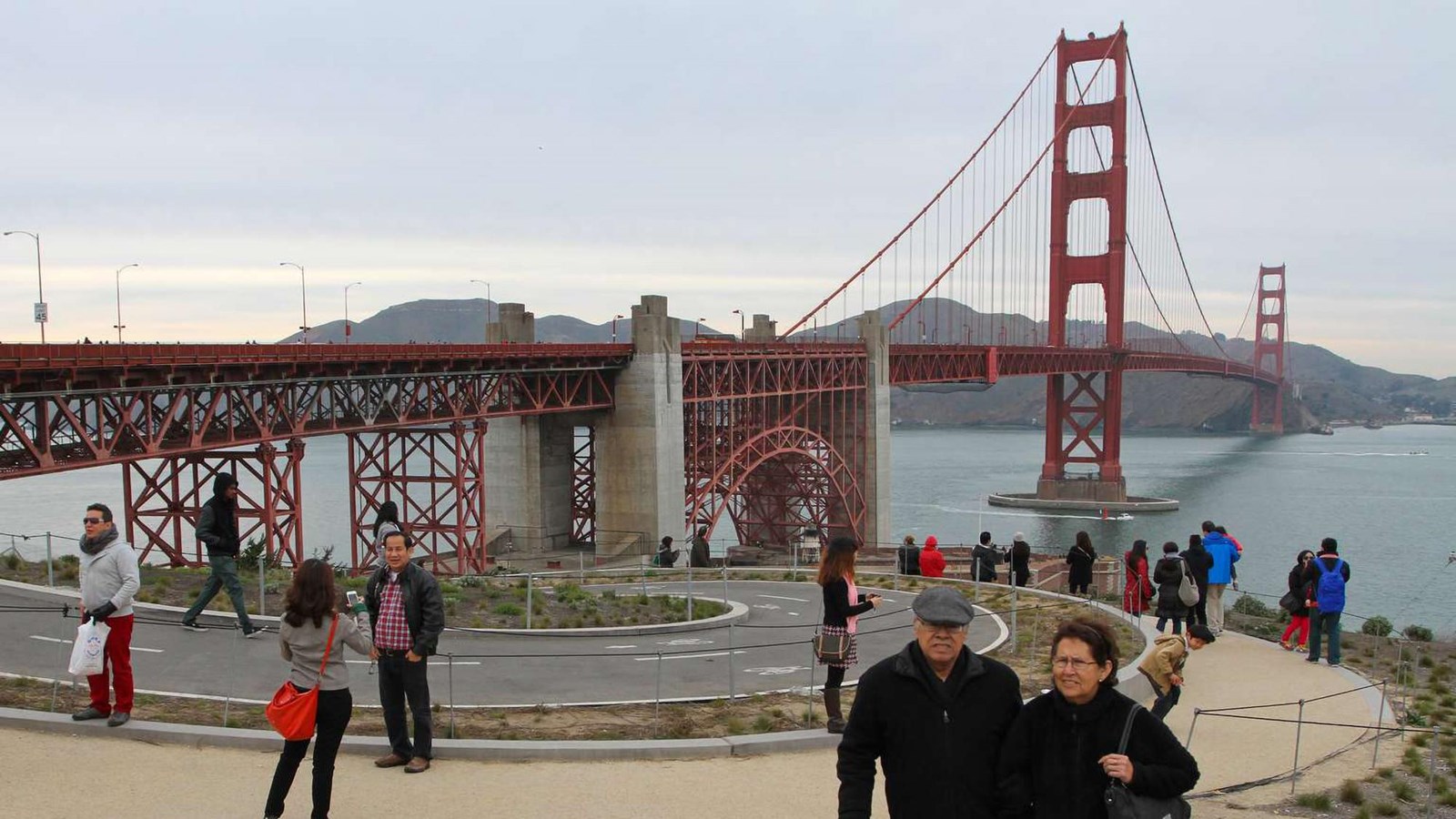 Visitors walking around the plaza with the Golden Gate Bridge in the distance. 