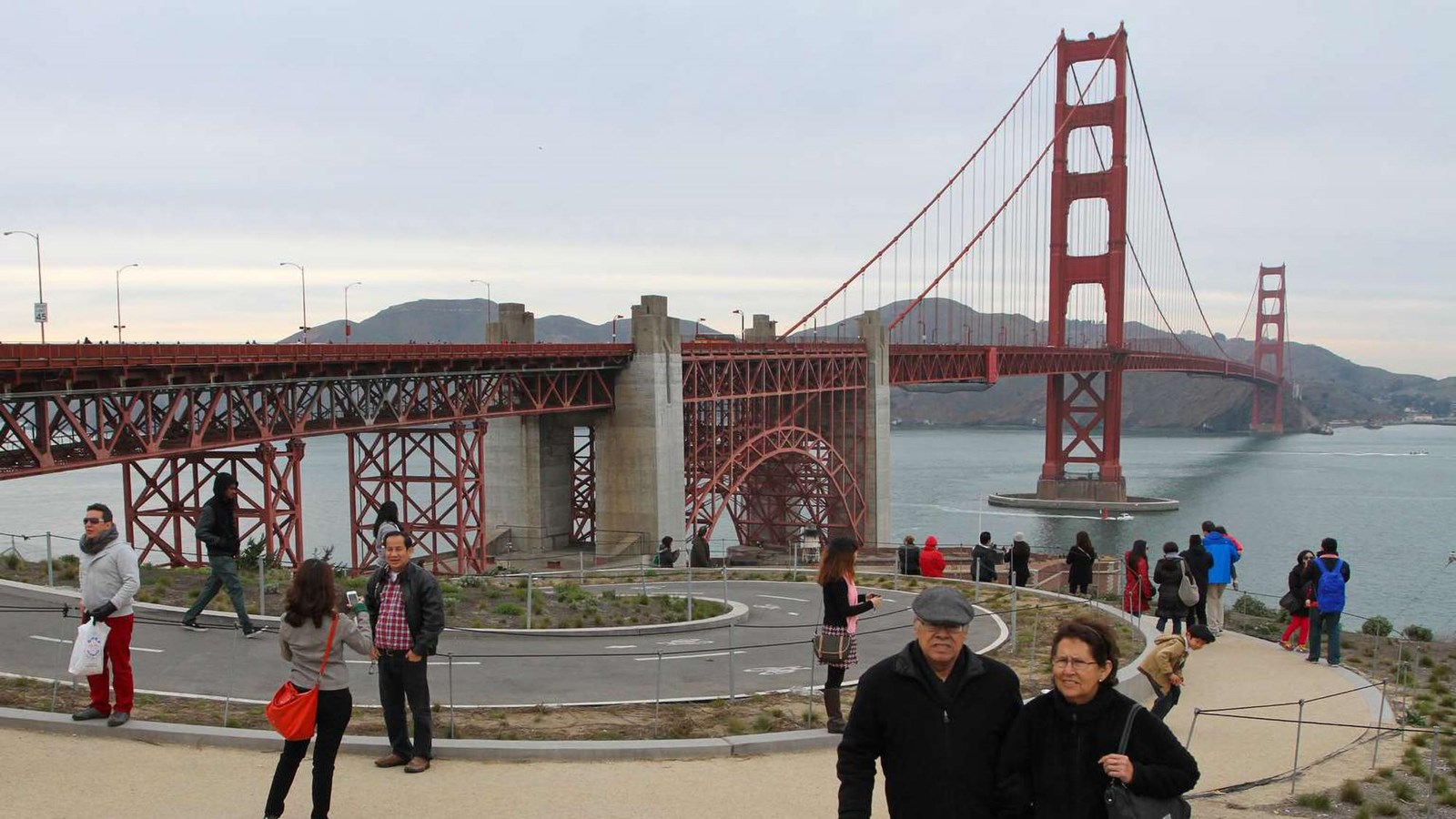 Visitors walking around the plaza with the Golden Gate Bridge in the distance.