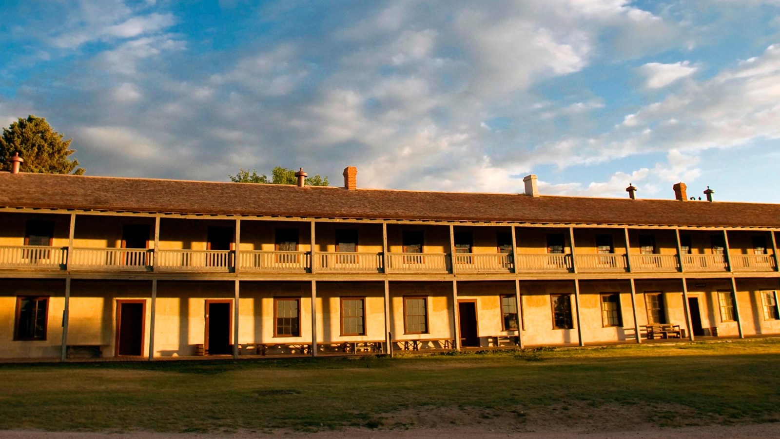 The cavalry barracks - a long lime-grout building - near dawn.