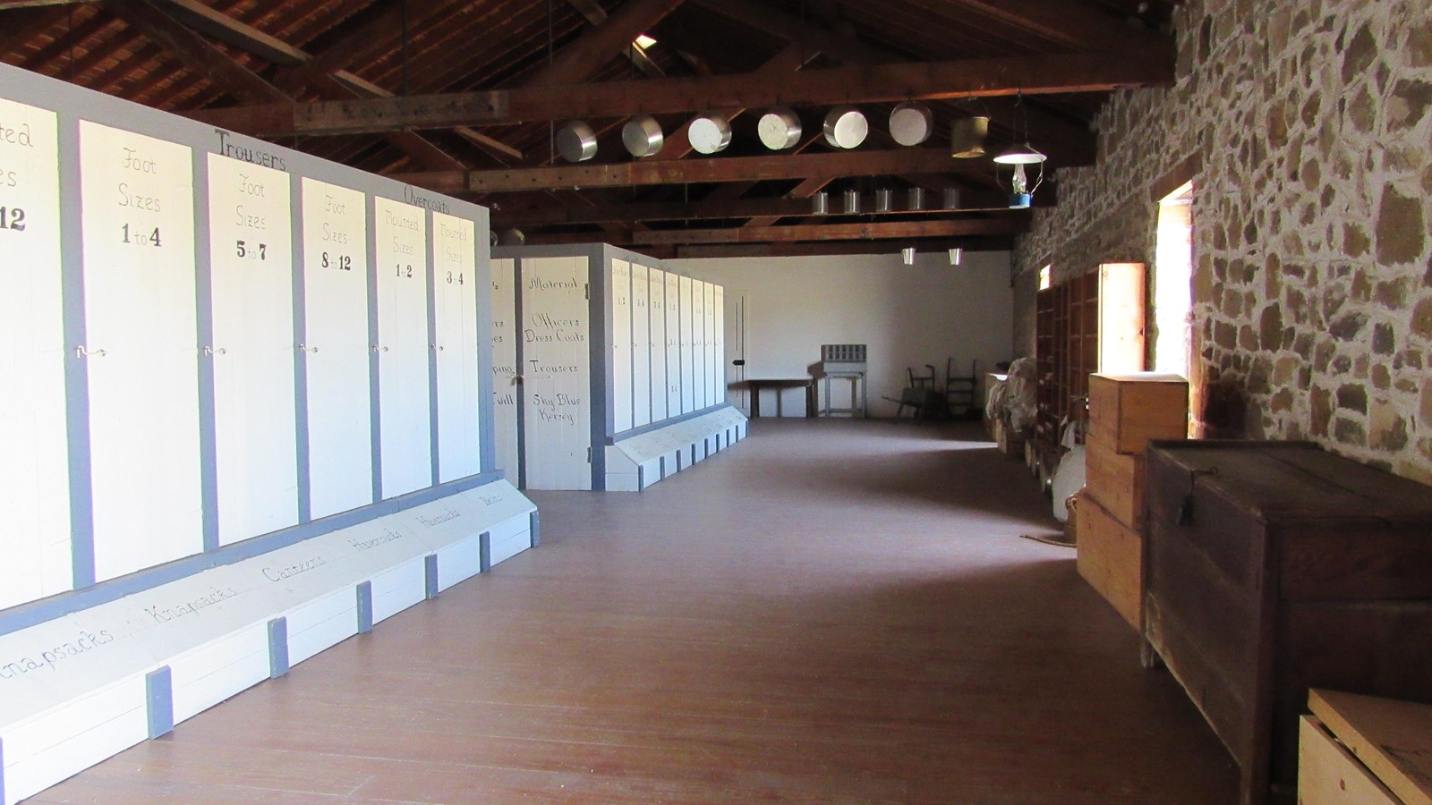 Large open room with unplastered sandstone walls and large storage cabinets.