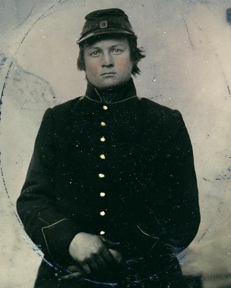 A young man wearing a Civil War era U.S. Army frock coat.
