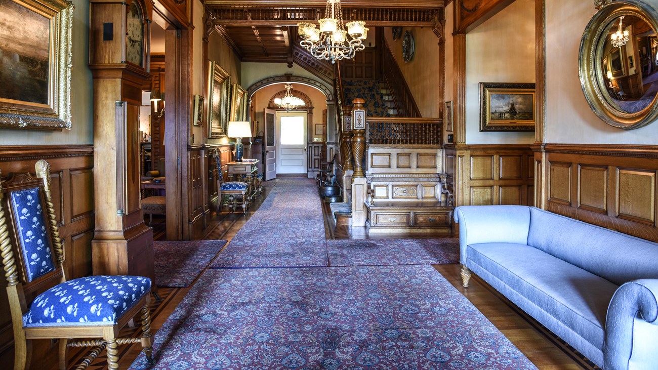 Entrance hallway of Victorian mansion with wood paneled walls