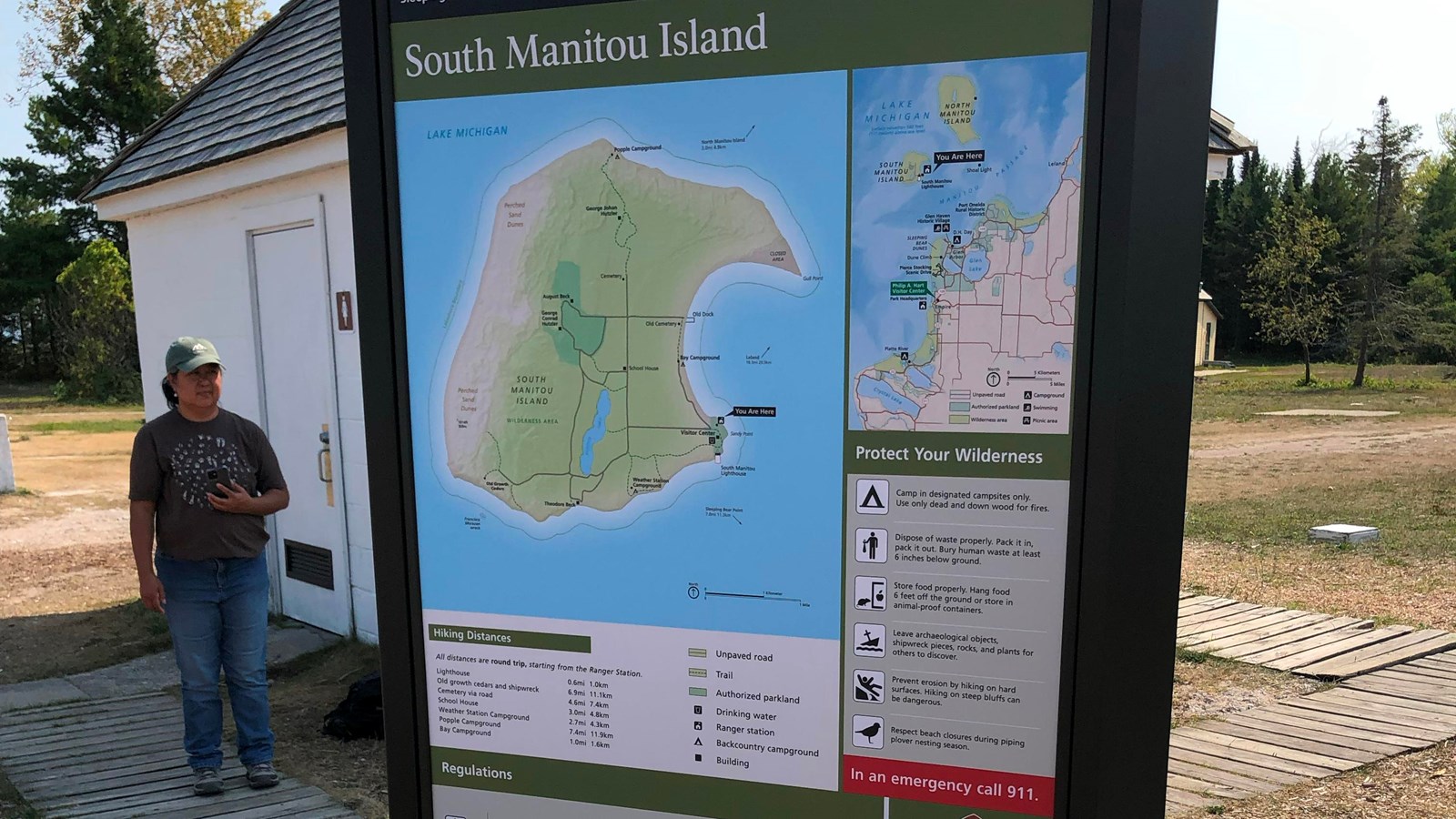 An orientation sign that shows a map of South Manitou Island and lists rules and regulations