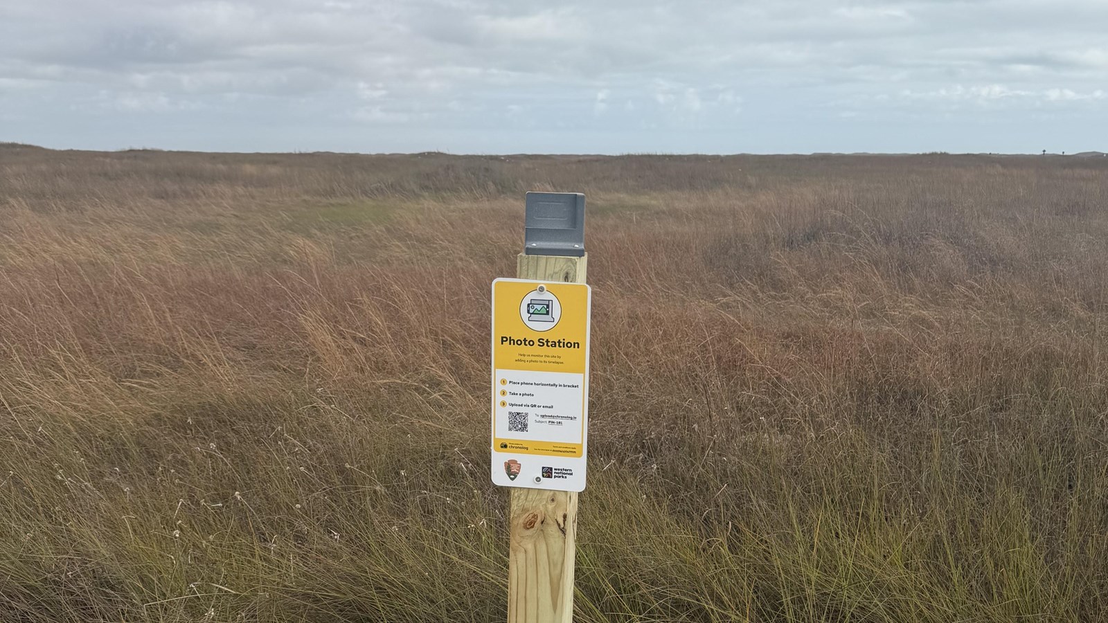 A photo monitoring station attached to a wooden post. 