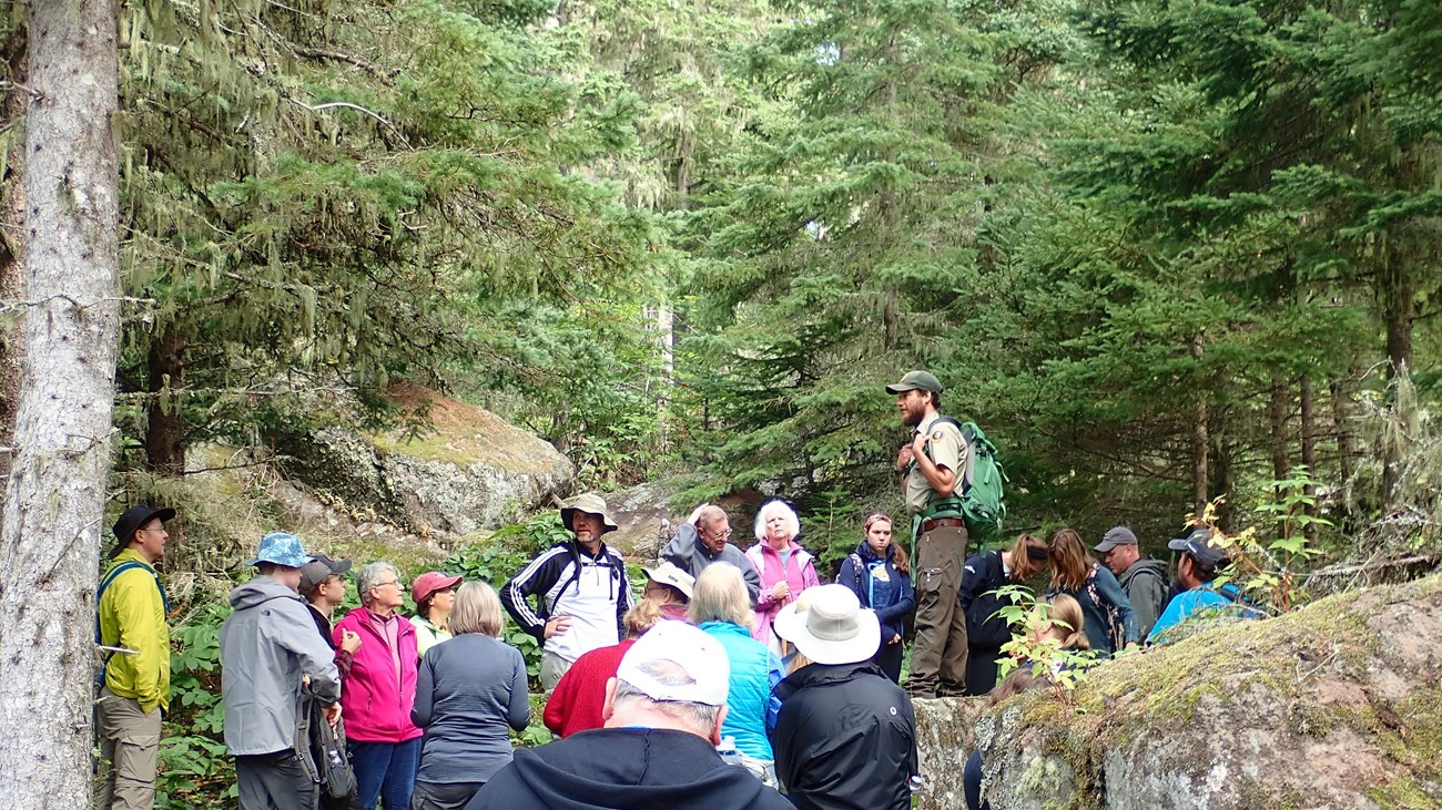 Park Ranger answers visitor questions on Isle Royale trail. 