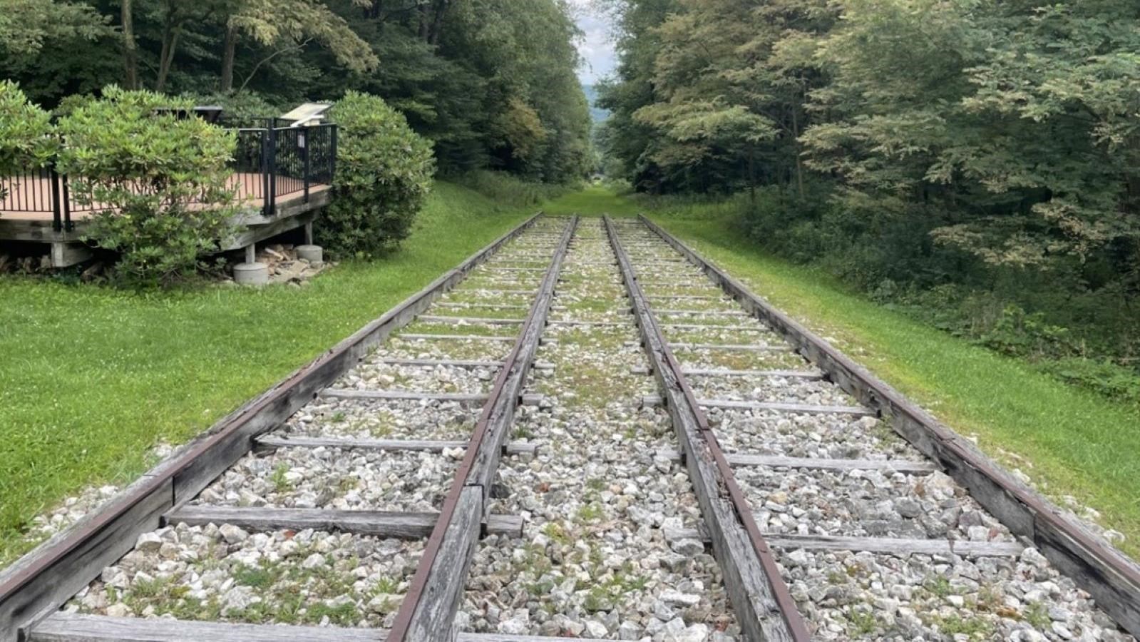 An overlook with reproduction wooden track with a piece of iron