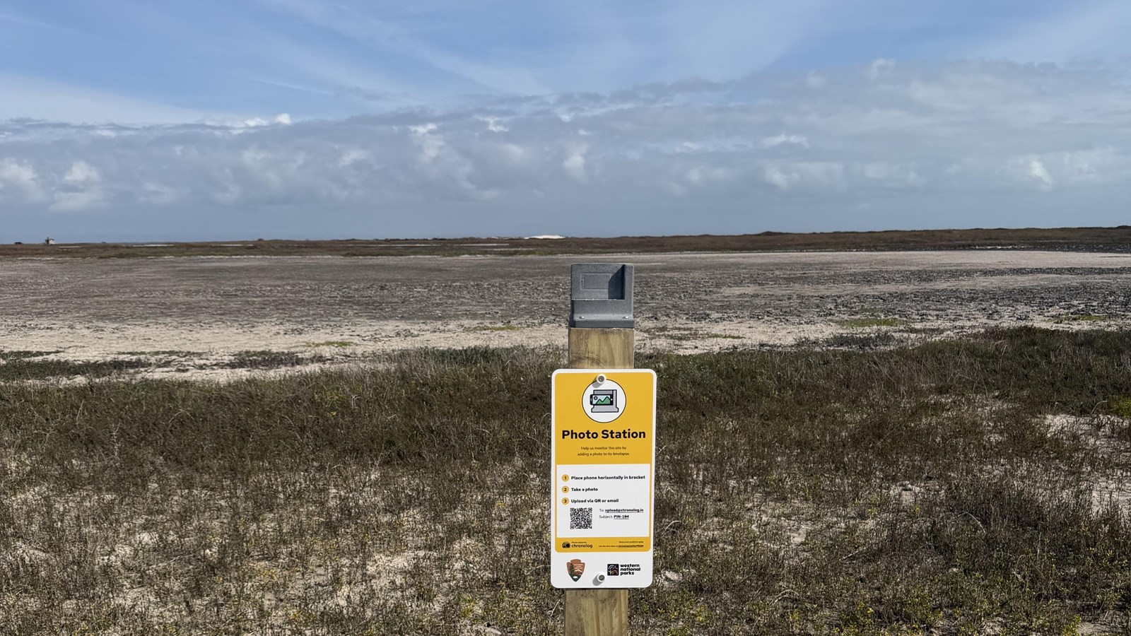 A photo monitoring station attached to a wooden post. 