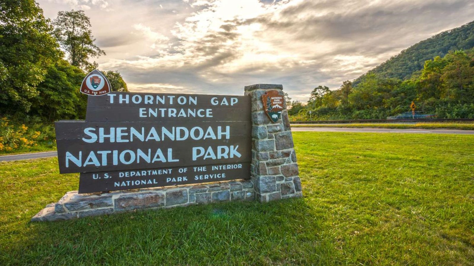 Wooden routed sign with white letters: Thornton Gap Entrance