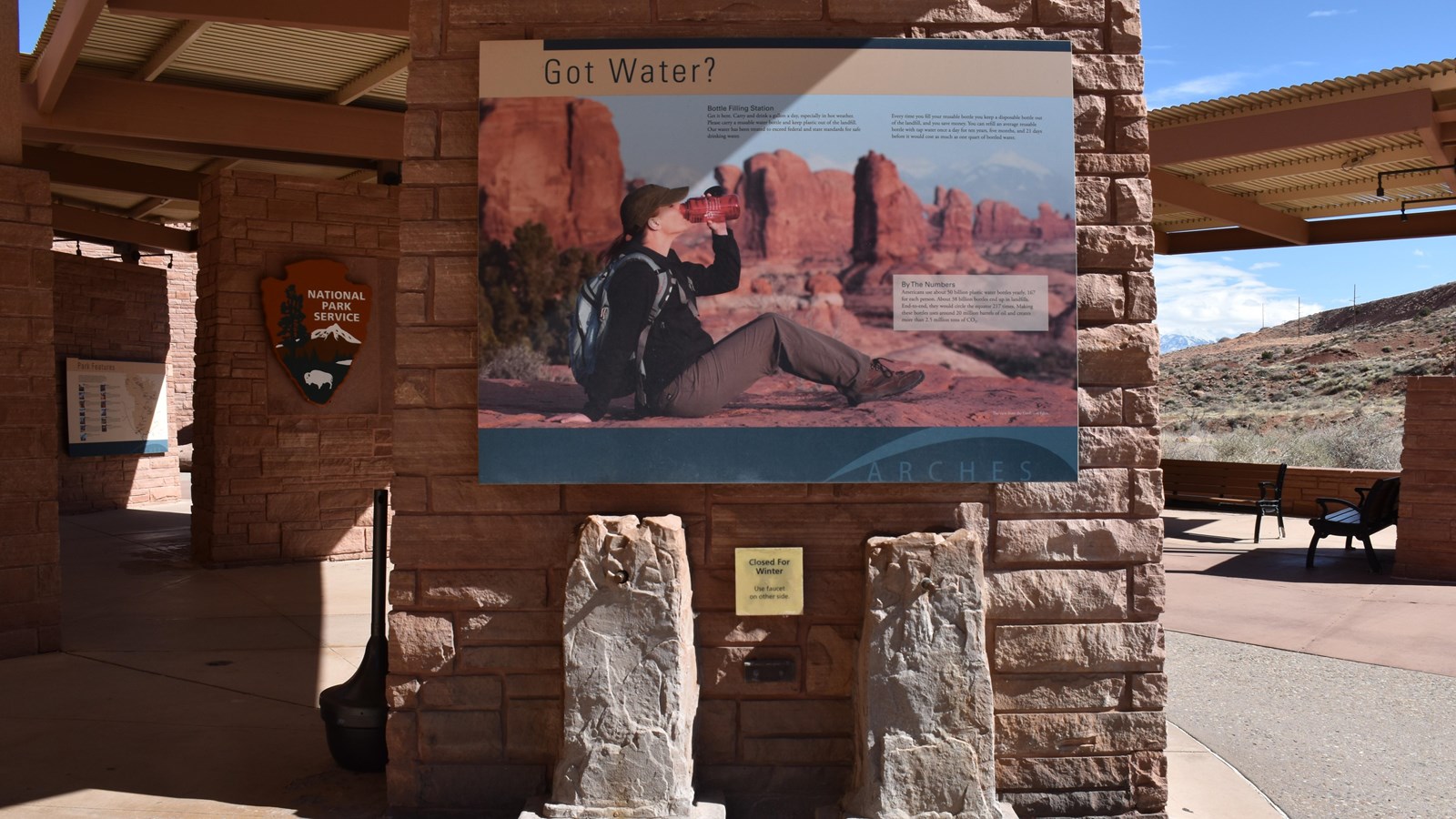 Panel with water information above two water filling spigots 