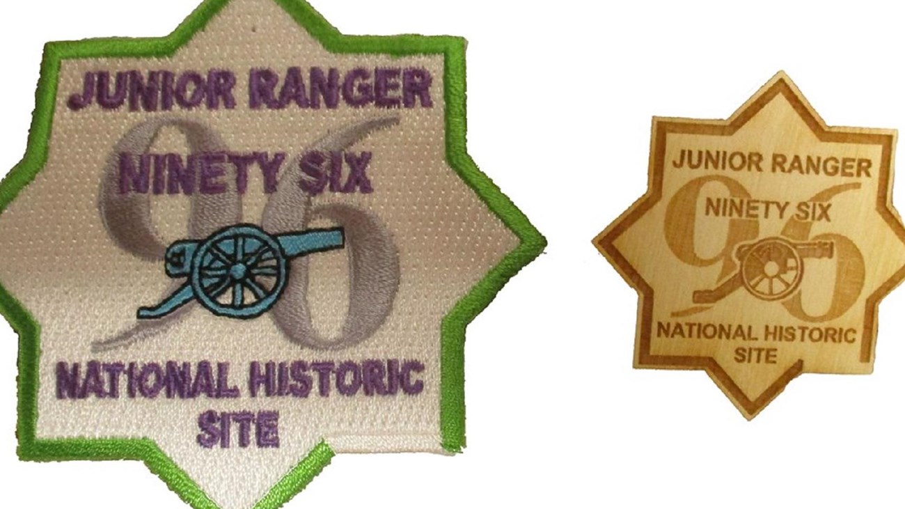 Both the embroidered Junior Ranger patch and the wooden badge are in the shape of an 8-pointed star.