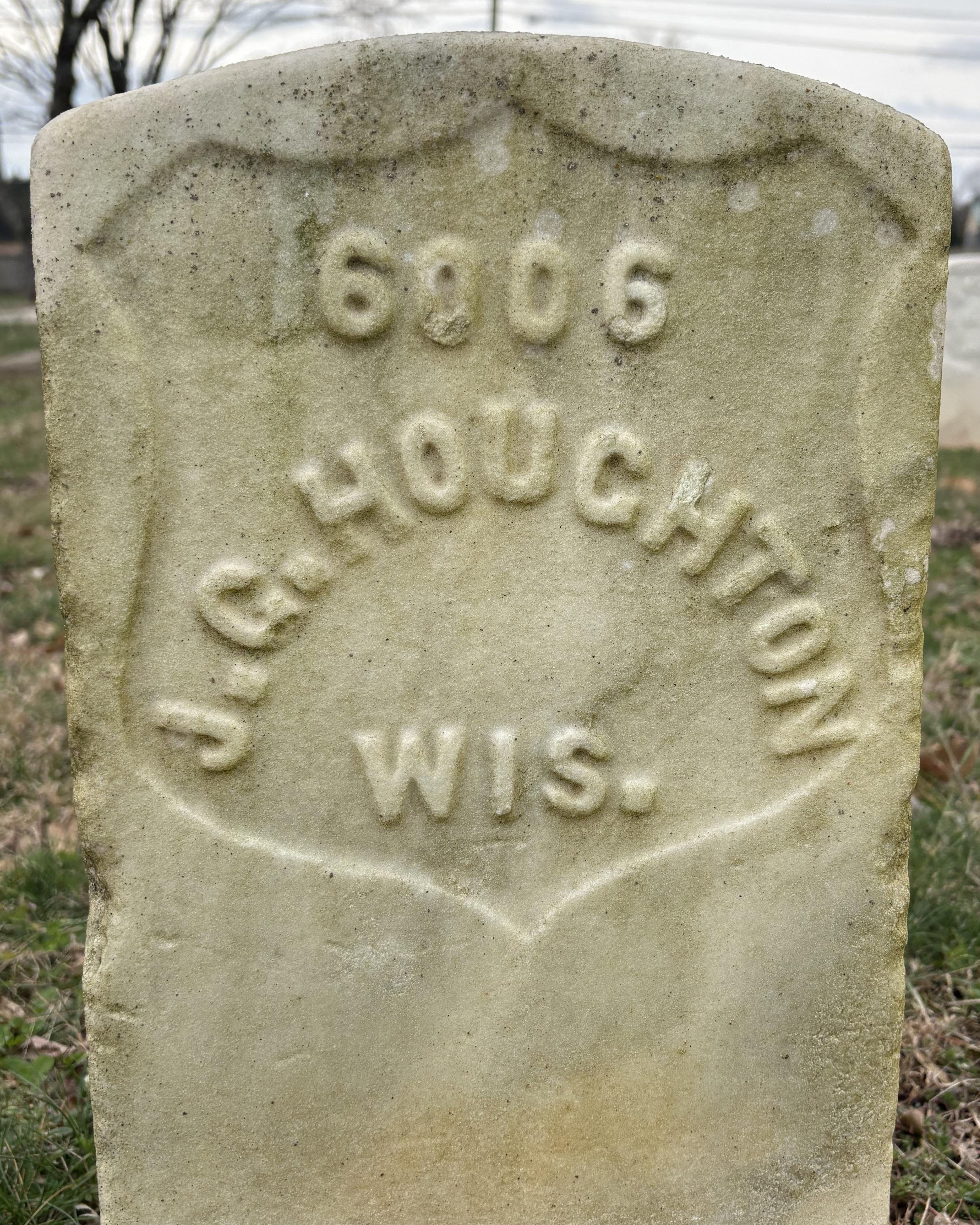Marble headstone reading "J.G. Houghton Wis." 