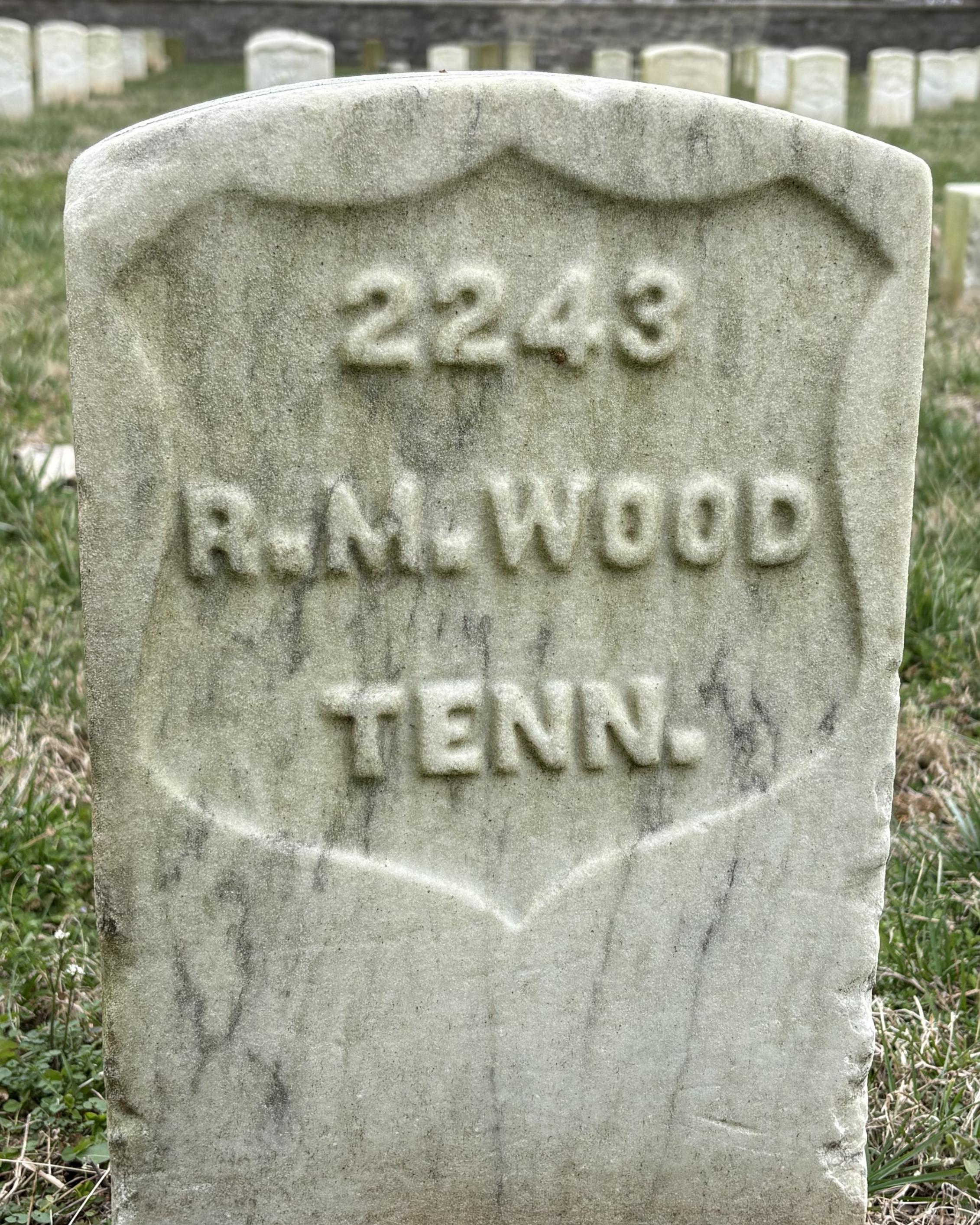 Marble headstone reading "R.M. Wood TENN." 
