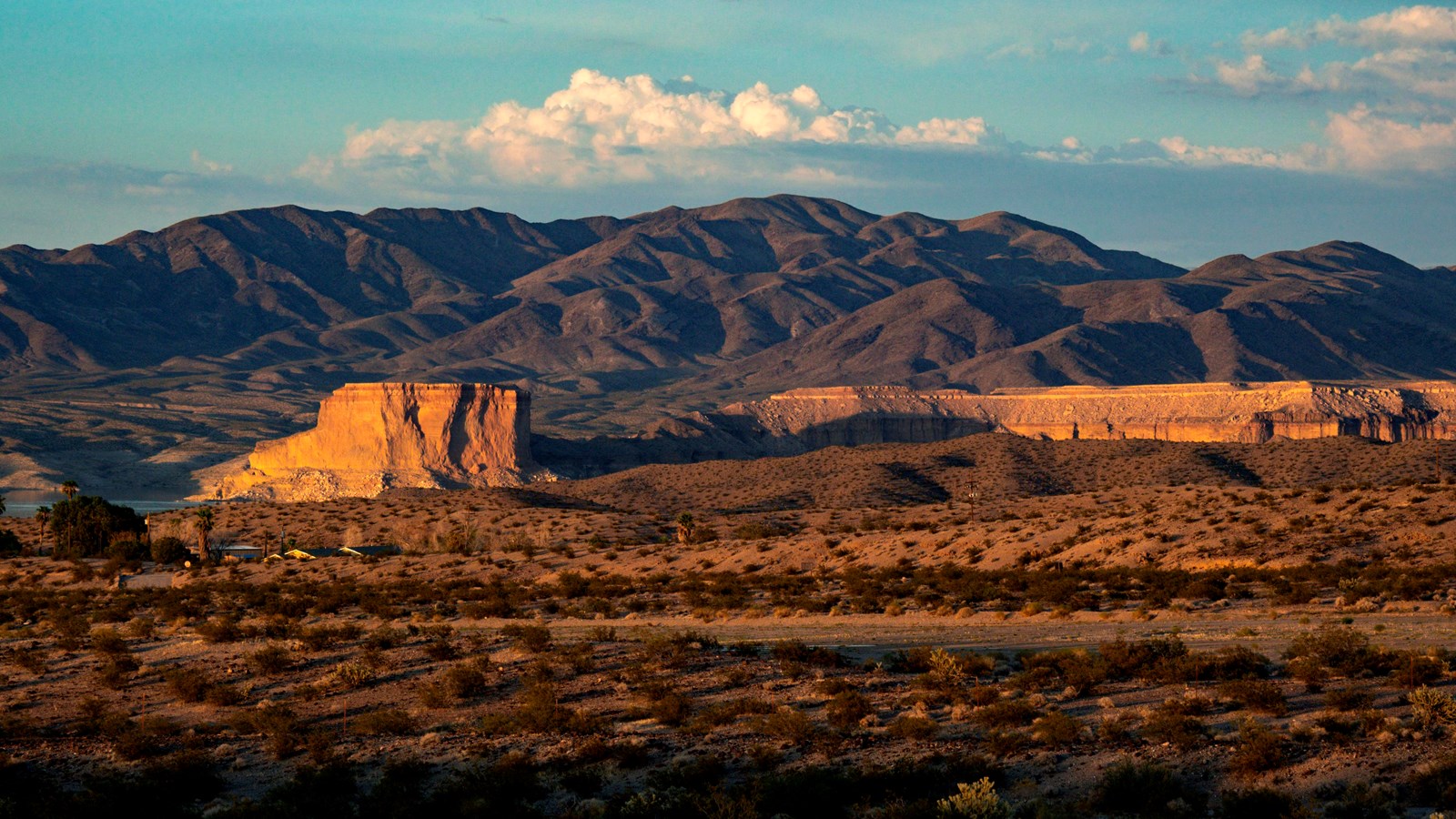A large rock formation in a desert landscape.