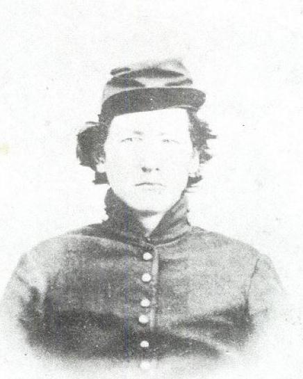Black and white photo of a young man with shaggy hair wearing a kepi and a Union civil war uniform.