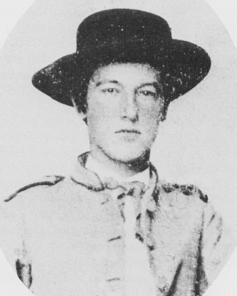 An oval cropped Civil War portrait photo shows a young soldier in a Confederate uniform.