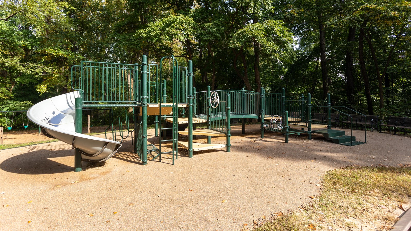 Playground equipment with platforms and a curling slide.