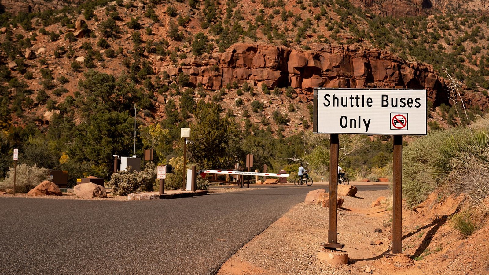 Photo of a road with a gate across it and a sign that reads