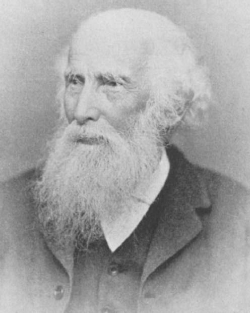 old white man, balding with white beard and mustache.