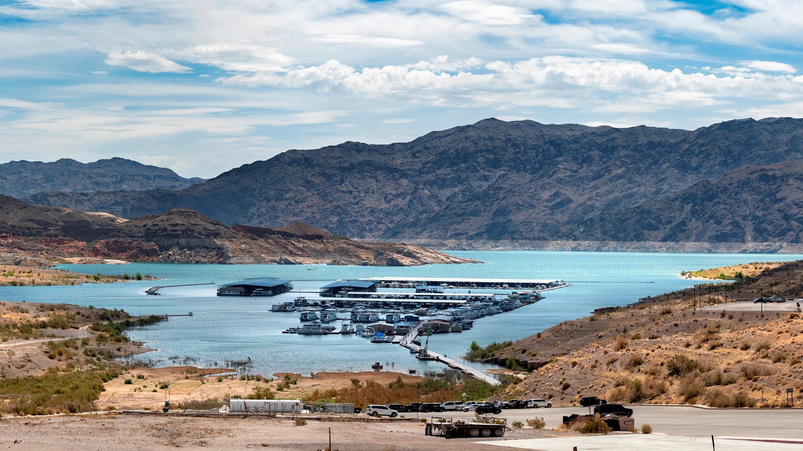 Aerial view looking over a marina and large body of water.