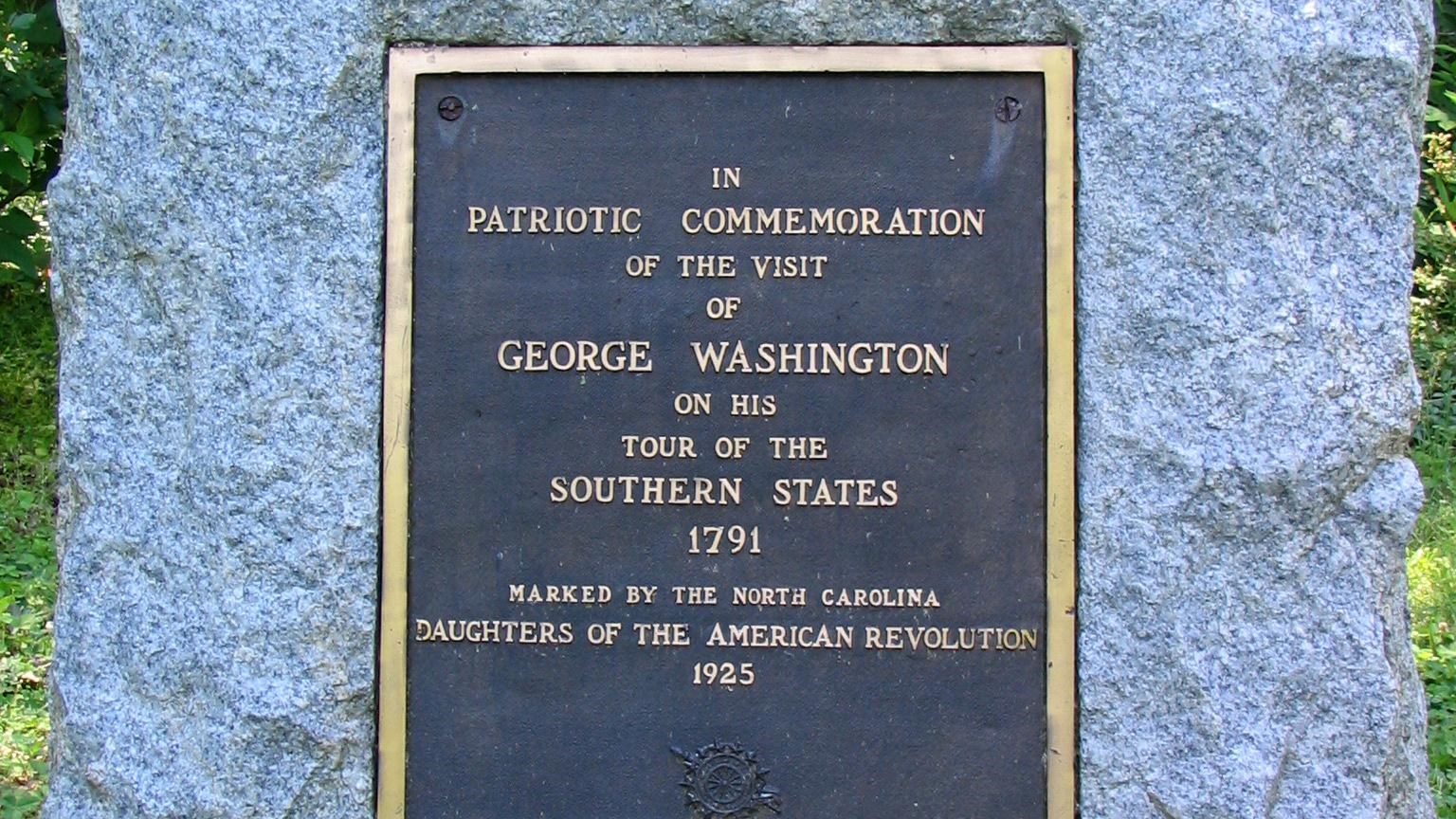 A 3 foot tall rough hewn block. In the center is a metal plaque dedicated to President Washington.