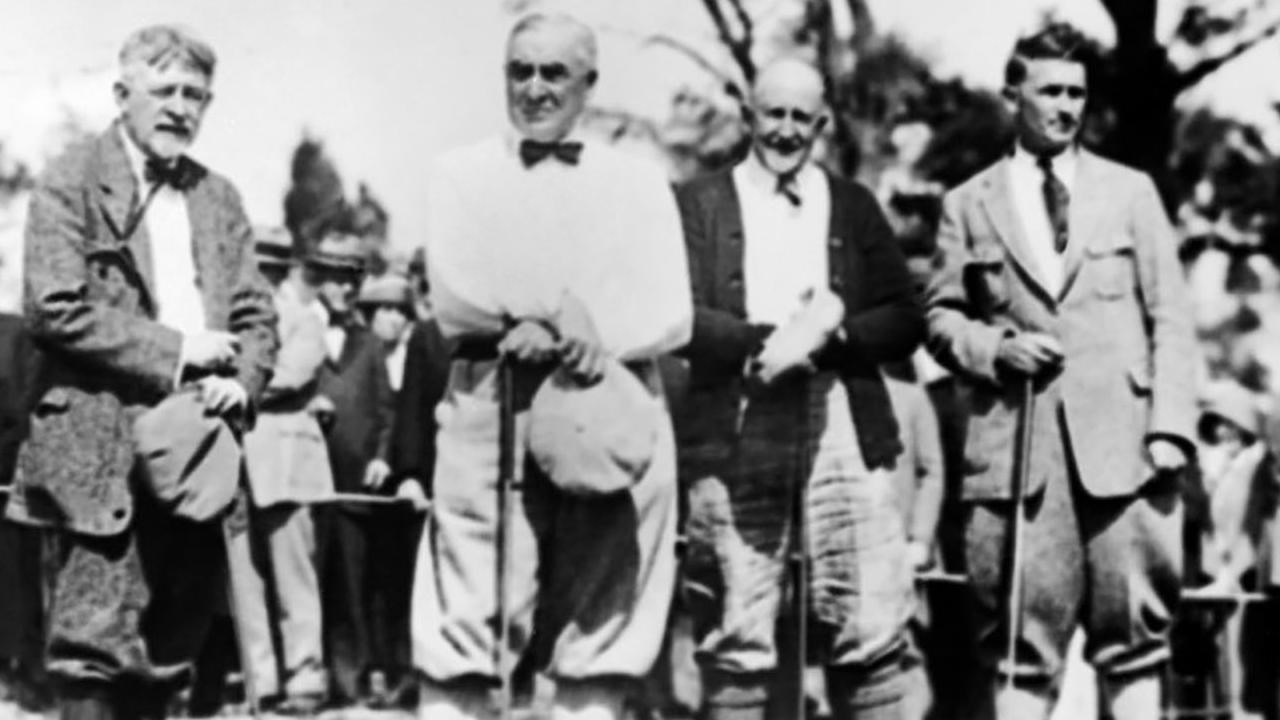 a black and white image of four men wearing dated golfing attire