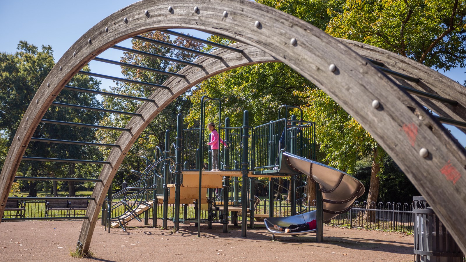 A jungle gym and play ground with large monkey bars. 