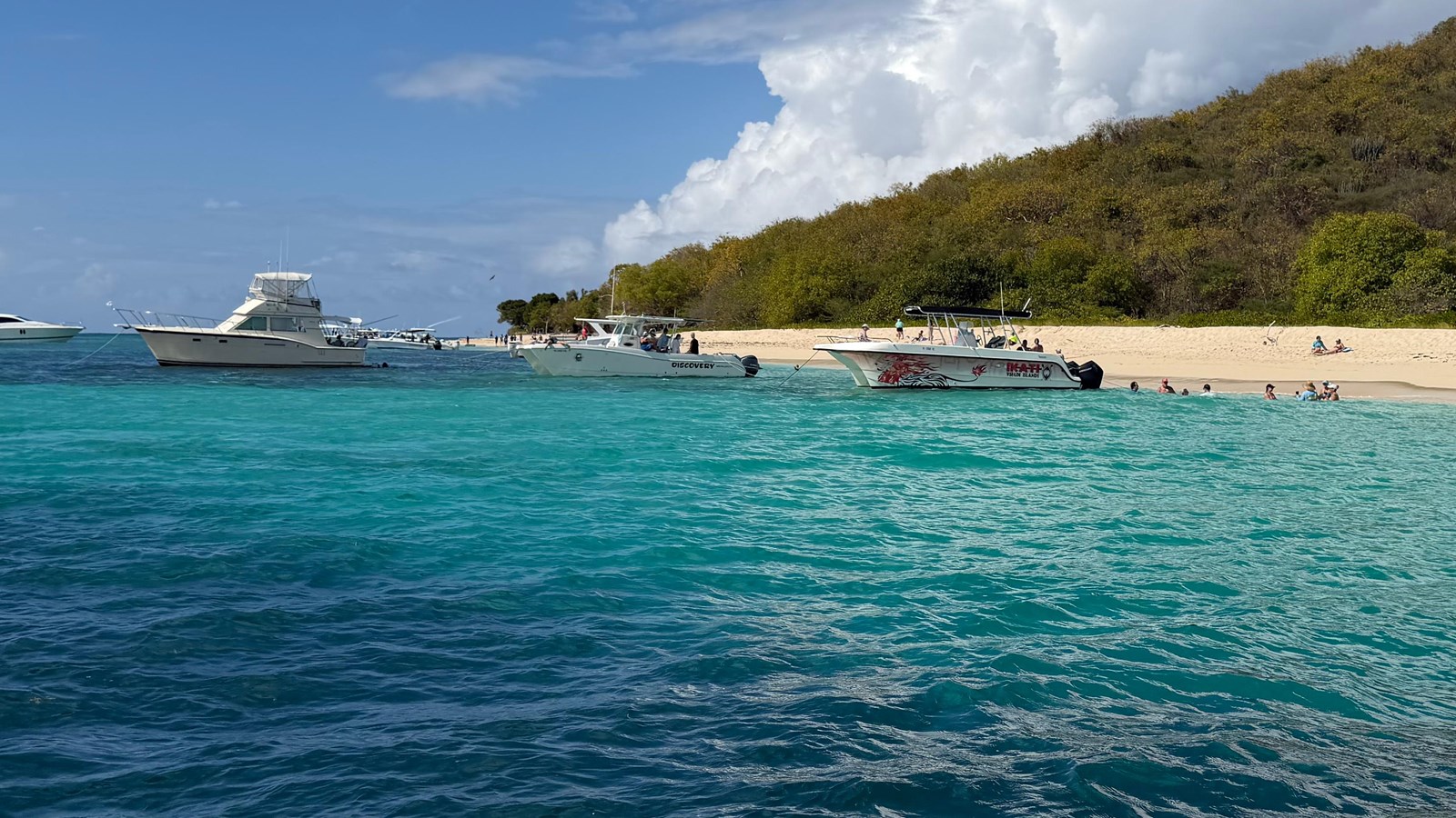 Photo of beach with boats, sea and island