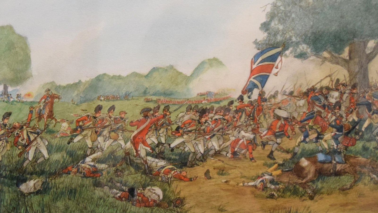 A line of British infantry charging over patchy ground. A line of support infantry follows behind.