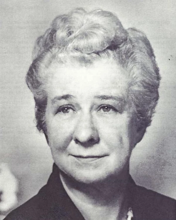Portrait of a woman with short white hair.