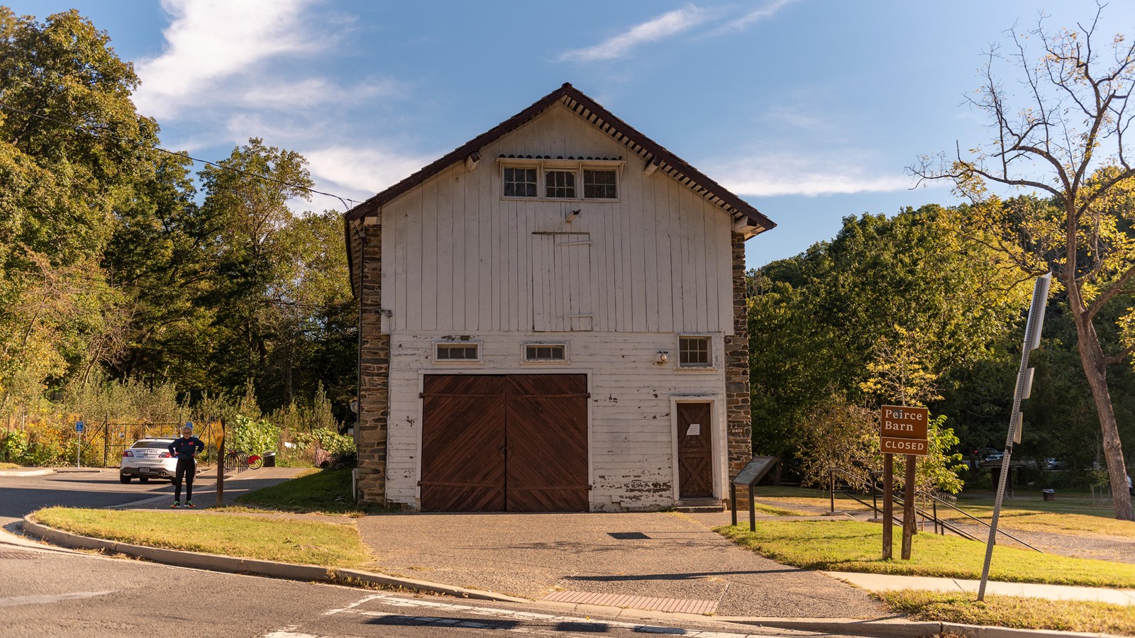 A large barn surrounded by trees. 