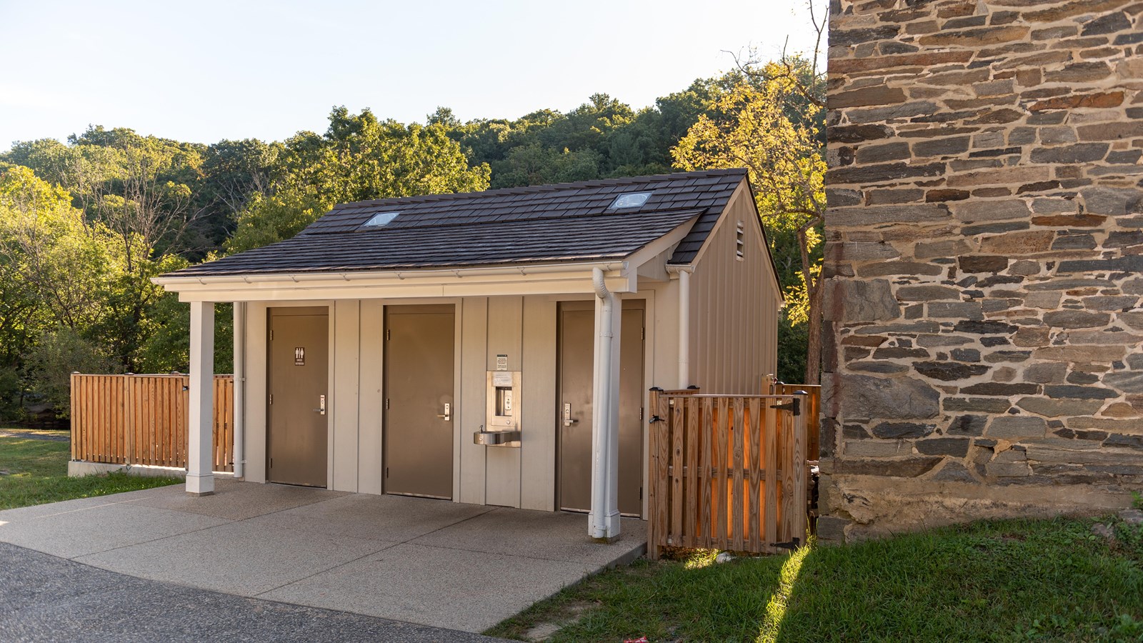 Pit toilet bathrooms next to a barn