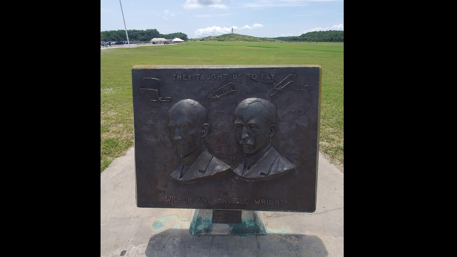 Colored photograph of the large bronze bas relief of Orville and Wilbur Wright.