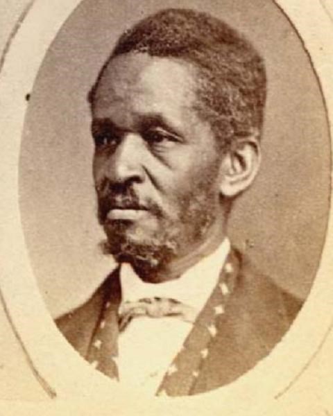 Side profile of African American Lewis Hayden, with cropped hair, long sideburns, and goatee.