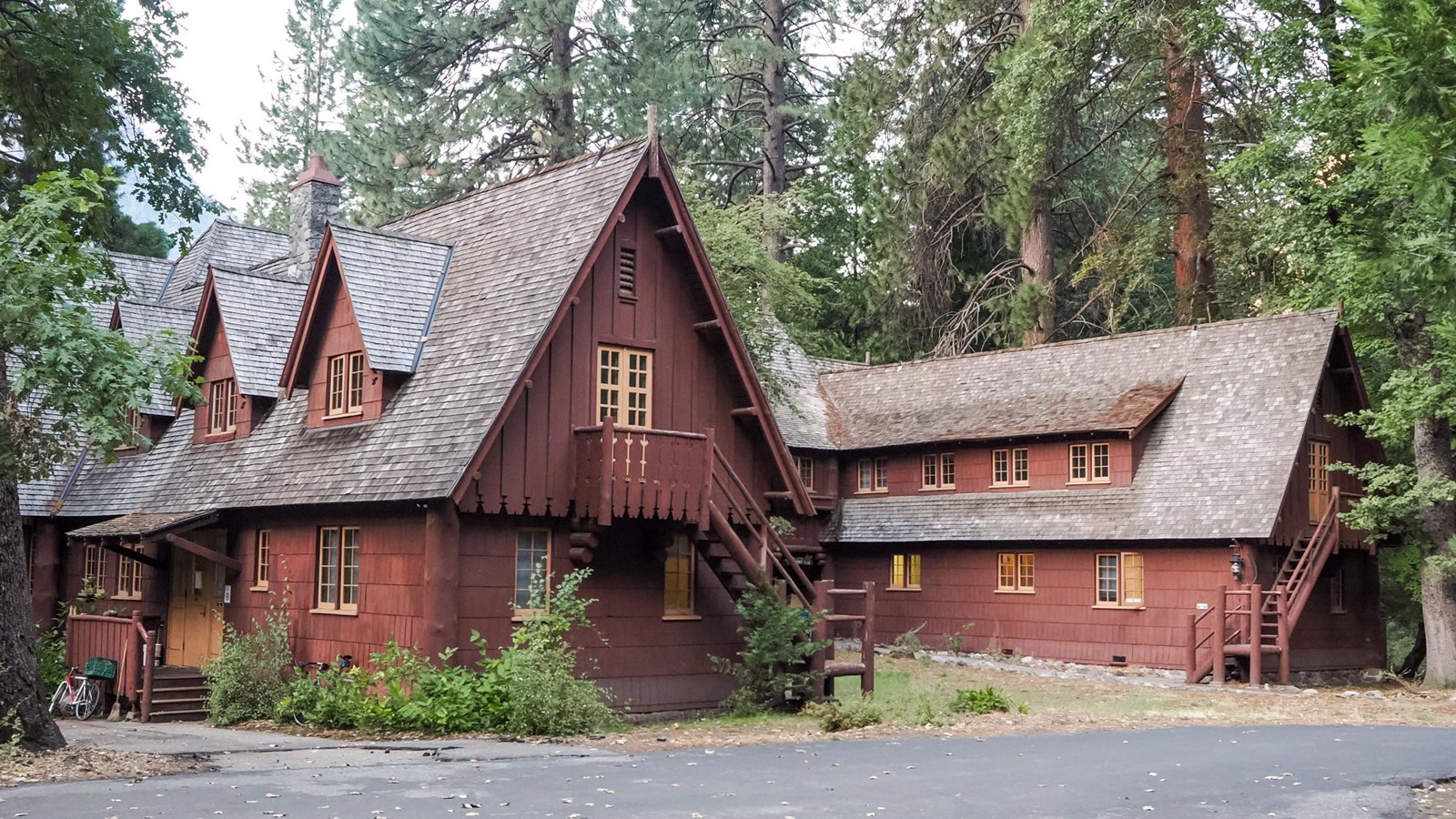 A two-story, U-shaped building with a steeply pitched roof, dormers, and a central courtyard