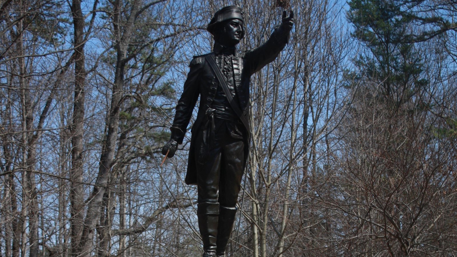 Atop a pedestal stands a statue of Joseph Winston. It points south and holds a sword in his hand.