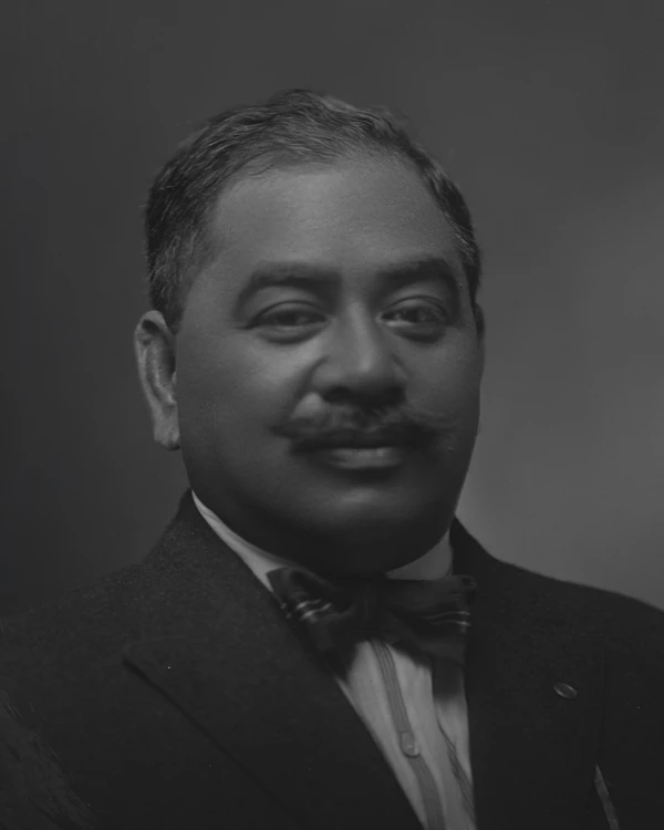 Prince Kūhiō portrait wearing suit and tie facing the camera.