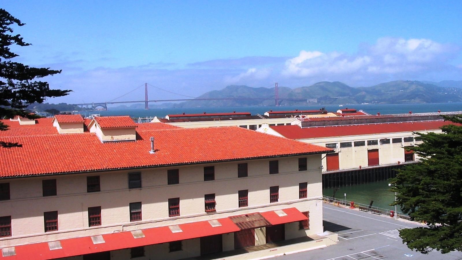 Warehouse in foreground with view of San Francisco Bay in background. 
